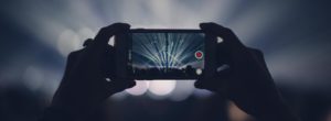 smartphone recording video at concert